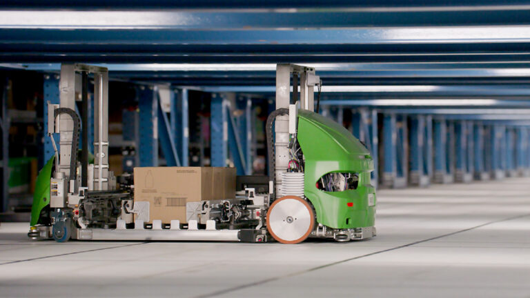 Photo of a SymBot with a case on a transfer deck